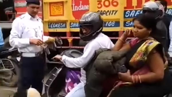 நடுரோட்டில் பெண்ணின் ஹெல்மெட்டை உடைத்த போலீஸ்காரர்... காரணம் தெரிந்தால் அதிர்ச்சியடைவீர்கள்