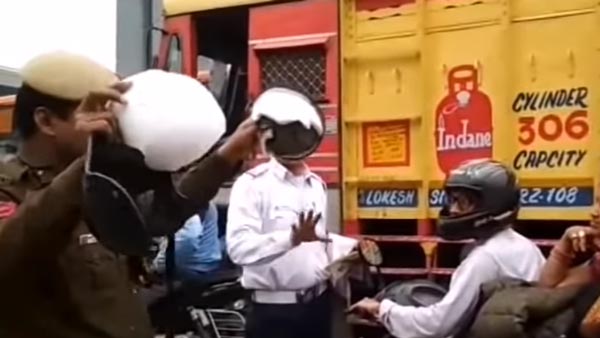 நடுரோட்டில் பெண்ணின் ஹெல்மெட்டை உடைத்த போலீஸ்காரர்... காரணம் தெரிந்தால் அதிர்ச்சியடைவீர்கள்
